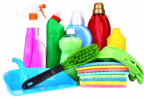 Carpet cleaning technician using safety procedures in a home